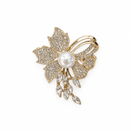 Gold-tone floral pearl-look rhinestone brooch with dangling clear stones, centered with generous white space