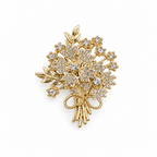 Golden Bouquet Brooch upright on a neutral white background, with gold-tone flowers, clear stones, leaf accents and a bow